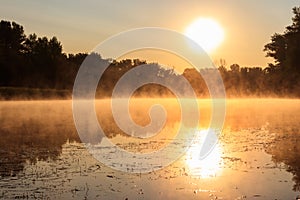 View of river in mist at sunrise. Fog over river at morning