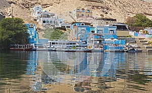 View of river nile in Aswan Egypt with traditional Nubian village on riverbank