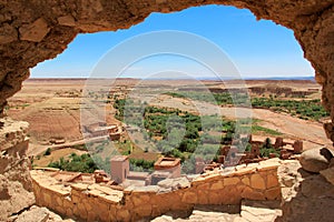 View of the river Onila valley through a hole in a wall of Ancient Kasbah in Ait-Ben-Haddou, Morocco.