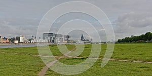 View on River Rine with Kranhaus buildings and cathedral from the green borders of Poller Wiesen park