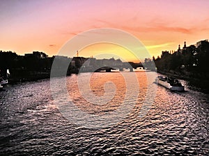 A view of the River Seine in Paris at dusk showing a sunset