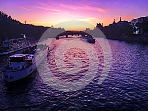A view of the River Seine in Paris at dusk showing a sunset