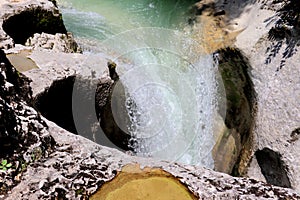 View of the River Seran in Bugey, France with the water flowing down rocks in the wilderness