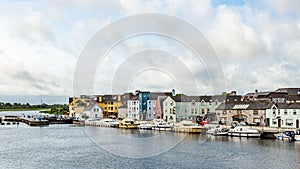 View of the river Shannon with boats anchored on the coast and the town of Athlone