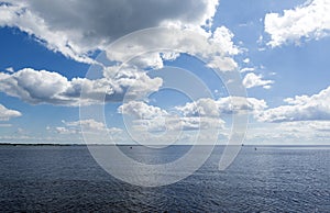 View of river, sky with clouds, horizon