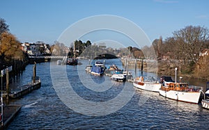 View of the River Thames at Teddington, west London, UK, with blue sky and boats moored. photo