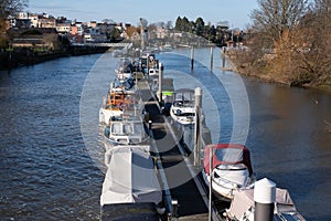 View of the River Thames at Teddington, west London, UK, with blue sky and boats moored. photo