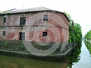 View of river, trees and old buildings in Kronshtadt, Russia