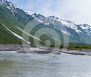 A view of a river tributary flowing down to Disenchartment Bay close to the Hubbard Glacier in Alaska