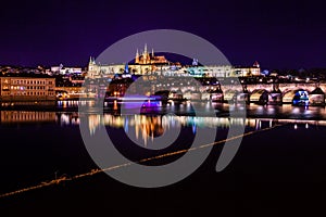 The view from the river Vltava at Charles Bridge and Prague Castle at night