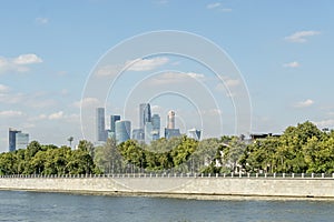 View of riverside of Moscow river and Moscow city skyscrapers behind the trees