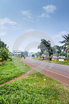 View of a road passing through a small town with houseâ€™s and vehicles, Rweteera, Fort Portal, Uganda