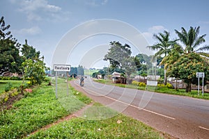 View of a road passing through a small town with houseâ€™s and vehicles, Rweteera, Fort Portal, Uganda