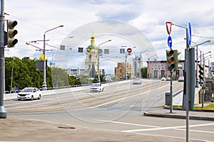 View on the road with traffic lights on Novospasskiy three-span bridge in Moscow, Russia. Summer morning. Taxi cars on
