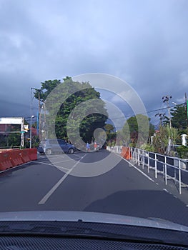 view of the road and trees visible from the car window