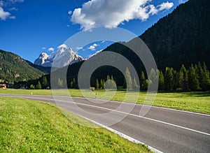 View of the road with turns in the mountain valley. The Dolomite Alps, Italy.