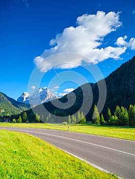 View of the road with turns in the mountain valley. The Dolomite Alps, Italy.