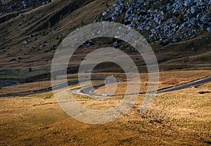 View of the road with turns in the mountain valley. Giau Pass, San Vito di Cadore, Province of Belluno, Italy. The Dolomite Alps,