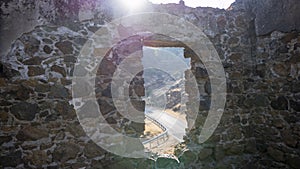 View of road from the window of a stone house