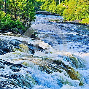 Roaring water cascade on a river bend