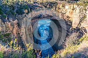 The view of rock bridge of the Tasman Arch and ocean