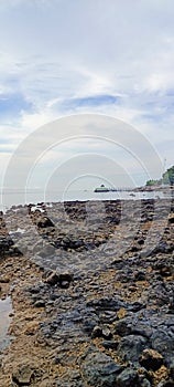 the view of the rock in the evening when the sea water recedes photo