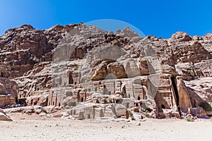 A view of a rock face with cave dwellings in the ancient city of Petra, Jordan