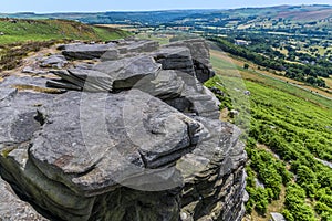 A view of rock strata and large slabs of Gritstone on the top of the Bamford Edge, UK