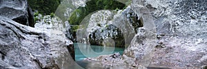 View through the rocks of a beautiful green soca river