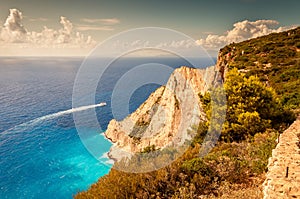 The view from the rocks of a boat leaving the Navagio Beach