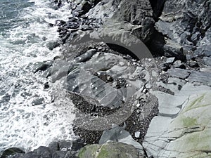 View from the rocks down to the strange-shaped boulders at low tide