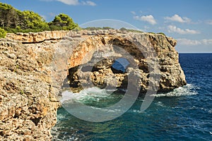 View on rocks with hole and deep blue sea.Mallorca Island, Spain