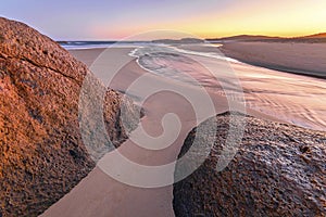 a view of a rocky beach at dawn in South West Rocks in Australia