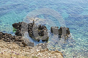 View of the rocky shore and crystal clear water of Aegean Sea