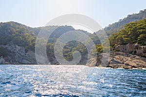 View of the rocky shore from the sea. Mediterranean Sea in Turkey. Popular tourist places. Background