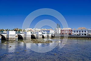 View of the Roman bridge Ponte Romano and Gilao river with town buildings to the rear, Tavira, Algarve, Portugal, Europe