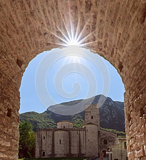 View of Roman Catholic abbey San Vittore alle Chiuse from the medieval arch. Genga, Marche, Italy photo