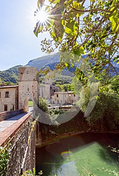 View of Roman Catholic abbey San Vittore alle Chiuse from the medieval bridge. Genga, Marche, Italy photo