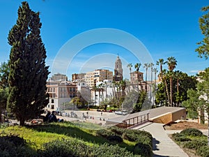 View of the roman theatre of Malaga, Spain on a sunny day. The Cathedral and Picasso Museum