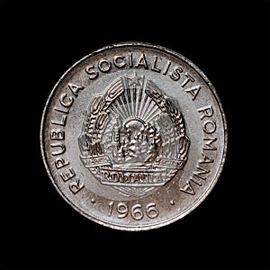 View of a Romanian 1966 fifteen Bani coin isolated on a black background
