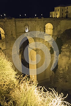 View of Ronda old stone bridge at night, Malaga, Spain