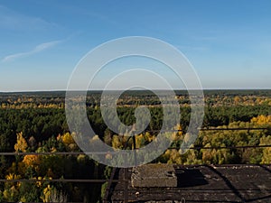 View from roof of ghost town Pripyat, post apocalyptic city and new sarcophagus of Chernobyl nuclear plant autumn season in