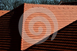 View of the roof made of red brick burnt tiles of the beaver type used in Central Europe on all historical roofs, especially in Au