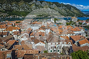 A view of the roof tops of Kotor old town and the fjord Bay of Kotor in summer