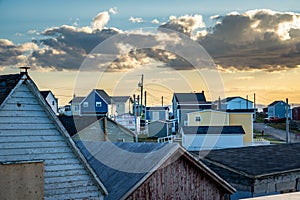 View of rooftops and East Coast homes overlooking a distant Atlantic sunset in Bonavista Newfoundland Canada