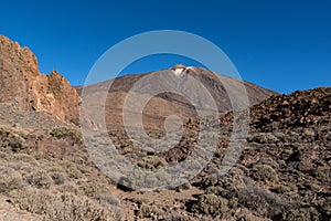 View of Roques de GarcÃ­a unique rock formation with famous Pico del Teide mountain volcano summit in the background on a sunrise