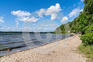 View of the Roskilde Fjord with a sandy beach and forest on the shoreline