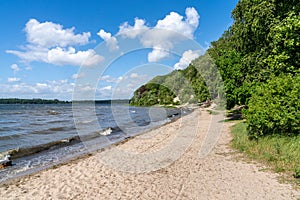 View of the Roskilde Fjord with a sandy beach and forest on the shoreline