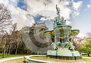 A view of Ross fountain at Princes Street gardens with Edinburgh Castle on the background in Edinburgh, Scotland