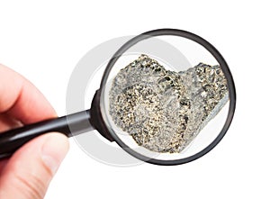 View of rough peridotite rock through magnifier